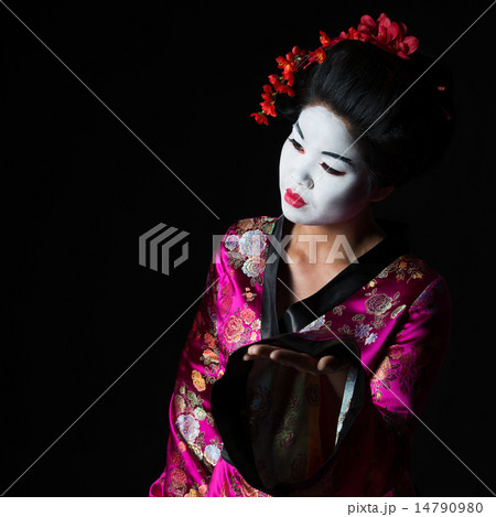 Portrait of geisha presenting something isolated on black Portrait of geisha presenting something isolated on black 14790980