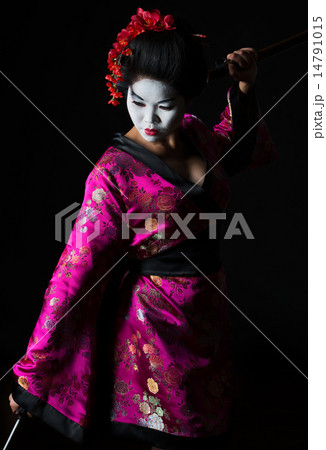 Portrait of geisha dancing with sword isolated on black 14791015