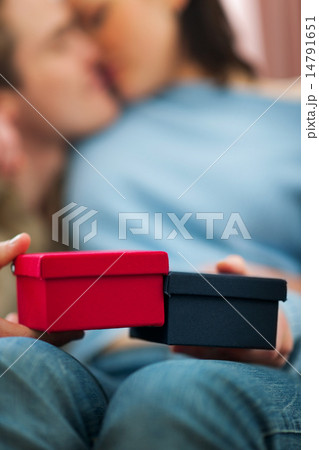 Closeup on present boxes holding by romantic couple 14791651