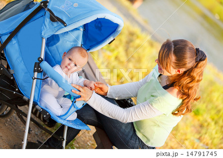 Happy mother holding baby's hand . Happy mother holding baby's hand . 14791745