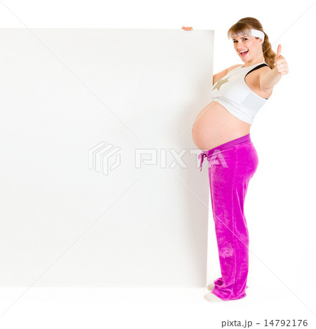 Smiling beautiful pregnant woman holding blank billboard and showing thumbs up gesture. Smiling beautiful pregnant woman holding blank billboard and showing thumbs up gesture. 14792176