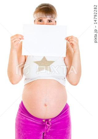 Pregnant woman holding empty white paper in front of her face. 14792282