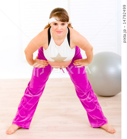 Smiling beautiful pregnant woman doing exercise at living room. Smiling beautiful pregnant woman doing exercise at living room. 14792499