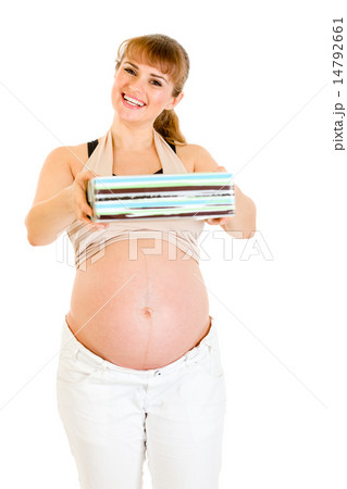Smiling pregnant woman holding present for her baby . Smiling pregnant woman holding present for her baby . 14792661