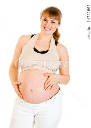 Smiling beautiful pregnant woman holding her belly isolated on white. Smiling beautiful pregnant woman holding her belly isolated on white. 14792665
