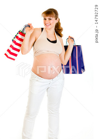 Happy pregnant female holding shopping bags in hands. Happy pregnant female holding shopping bags in hands. 14792729