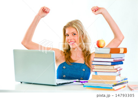 Smiling beautiful girl sitting at table and rejoicing success Smiling beautiful girl sitting at table and rejoicing success 14793305