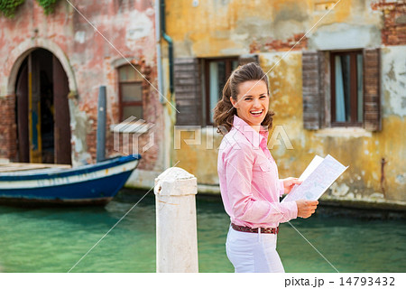 Portrait of happy young woman with map in venice, italy Portrait of happy young woman with map in venice, italy 14793432