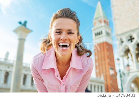 Portrait of happy young woman against campanile di san marco in Portrait of happy young woman against campanile di san marco in 14793433