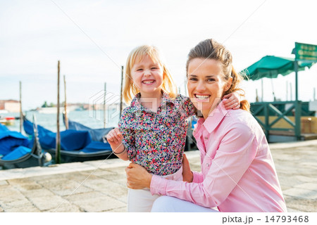 Portrait of happy mother and baby on grand canal embankment in v 14793468
