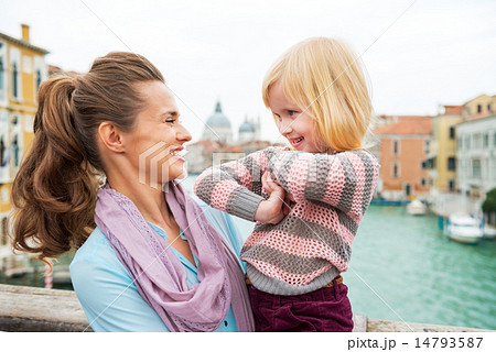 Portrait of happy mother and baby girl on bridge with grand cana 14793587