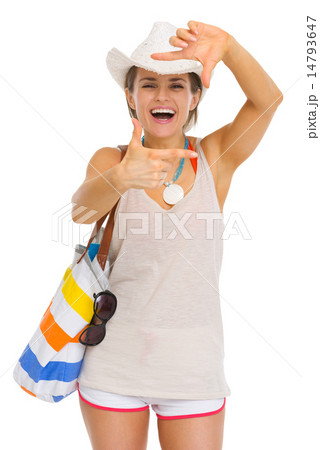 Smiling young beach woman in hat framing with hands 14793647
