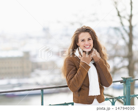 Portrait of smiling young woman in winter jacket outdoors 14794030