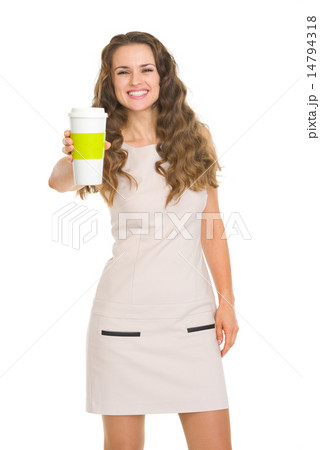 Smiling young woman giving coffee cup Smiling young woman giving coffee cup 14794318