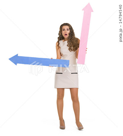 Surprised young woman with arrows pointing 14794540