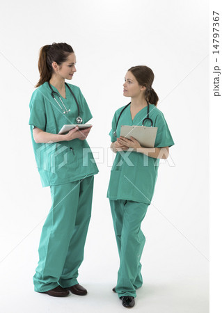 Two female healthcare workers wearing uniform and stethoscope. 14797367