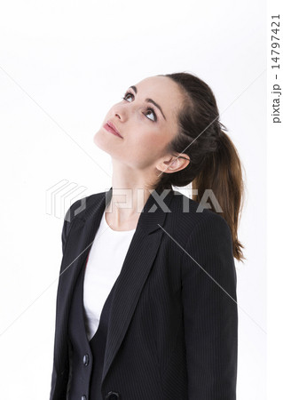 Thoughtful businesswoman looking up at copy space. 14797421