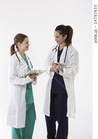 Two female healthcare workers wearing uniform and stethoscope. 14797635