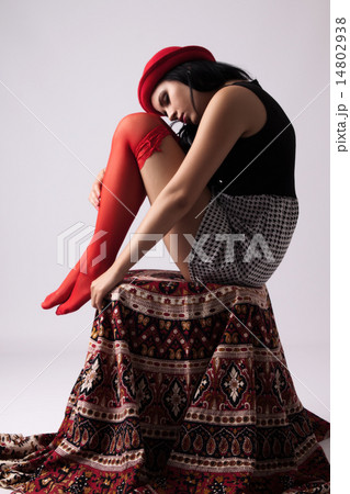 Young woman in a hat, sitting on a chair 14802938