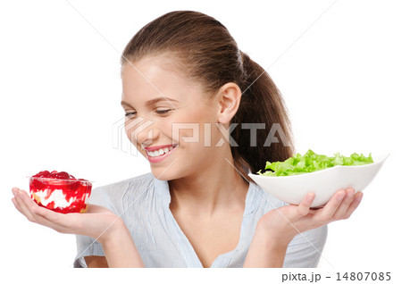 Pretty young woman choice salad or cake. Isolated Pretty young woman choice salad or cake. Isolated 14807085