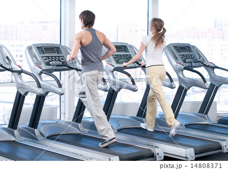 Young woman and man at the gym exercising. Running Young woman and man at the gym exercising. Running 14808371