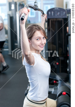 Powerful casual woman lifting weights in gym Powerful casual woman lifting weights in gym 14808380
