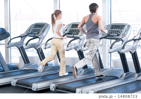 Young woman and man at the gym exercising. Running Young woman and man at the gym exercising. Running 14808723