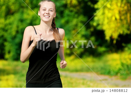Young woman running in green park 14808812
