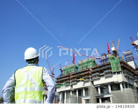 Construction worker looking at a building 14810830