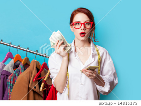 Young redhead designer with dollars Young redhead designer with dollars 14815375