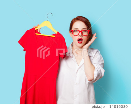 Young redhead designer with red dress Young redhead designer with red dress 14816080