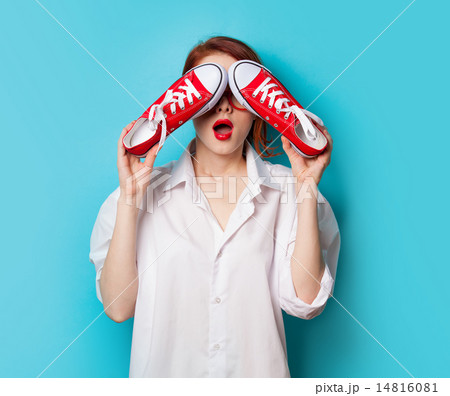 Surprised redhead girl in white shirt with gumshoes Surprised redhead girl in white shirt with gumshoes 14816081