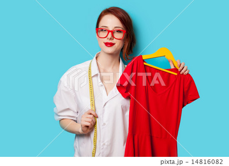 Young redhead designer with red dress Young redhead designer with red dress 14816082
