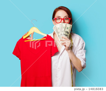 Surprised young redhead designer with dress and dollars 14816083