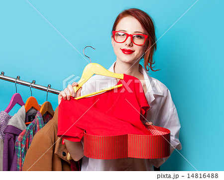 Young redhead designer with red dress Young redhead designer with red dress 14816488