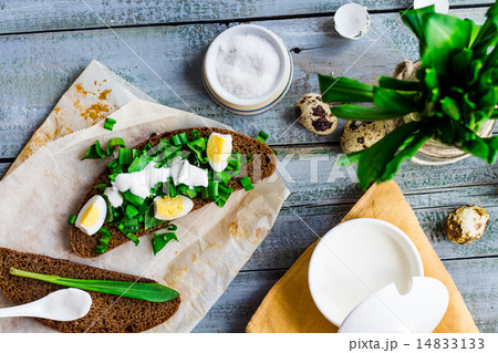 bread with wild garlic, sour cream and quail eggs 14833133