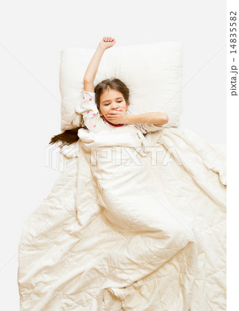 Isolated shot of little girl yawning in bed at morning Isolated shot of little girl yawning in bed at morning 14835582