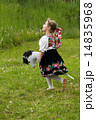 Little girl playing on a meadow 14835968