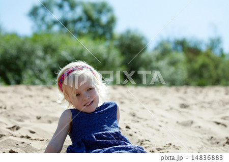 Portrait of cute blonde girl resting on beach 14836883