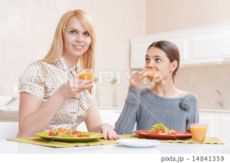 Mother and daughter drink juice Mother and daughter drink juice 14841359