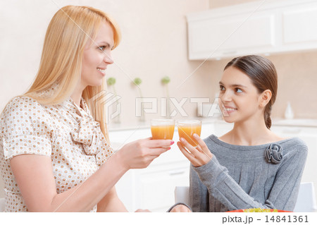 Mother and daughter drink juice Mother and daughter drink juice 14841361