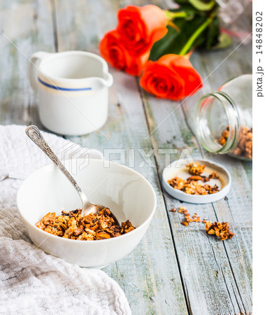 granola with nuts and dried fruits, flowers 14848202