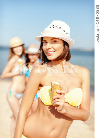 girl in bikini eating ice cream on the beach girl in bikini eating ice cream on the beach 14870888