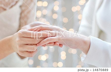 close up of lesbian couple hands with wedding ring 14870889