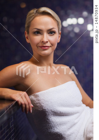 beautiful young woman sitting in bath towel 14870934