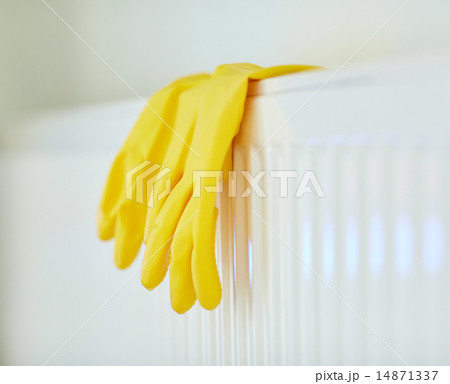 close up of rubber gloves hanging on heater close up of rubber gloves hanging on heater 14871337
