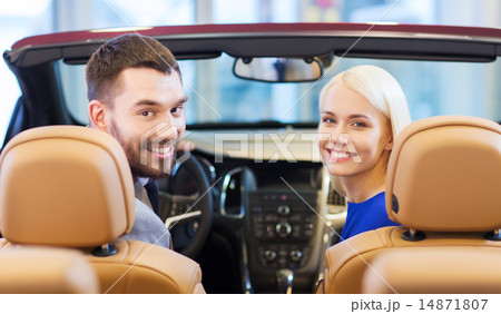 happy couple sitting in car at auto show or salon 14871807