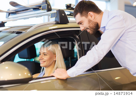 happy couple buying car in auto show or salon 14871914