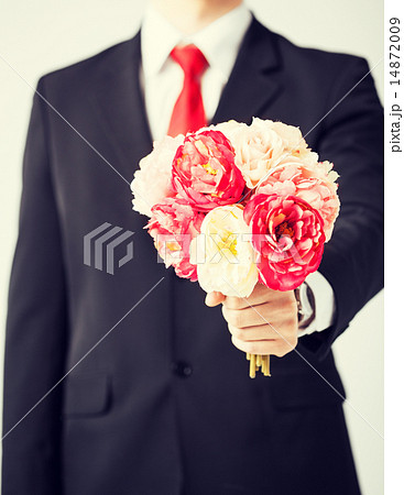 man giving bouquet of flowers man giving bouquet of flowers 14872009
