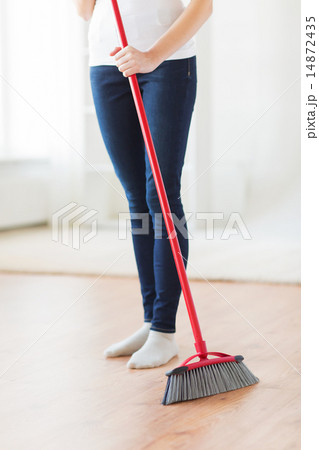 close up of woman legs with broom sweeping floor close up of woman legs with broom sweeping floor 14872435
